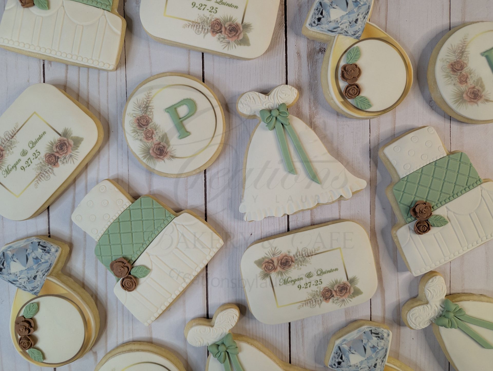 Pastel green and cream Easter-style decorated cookies with bows, bunnies, and floral designs on a striped surface