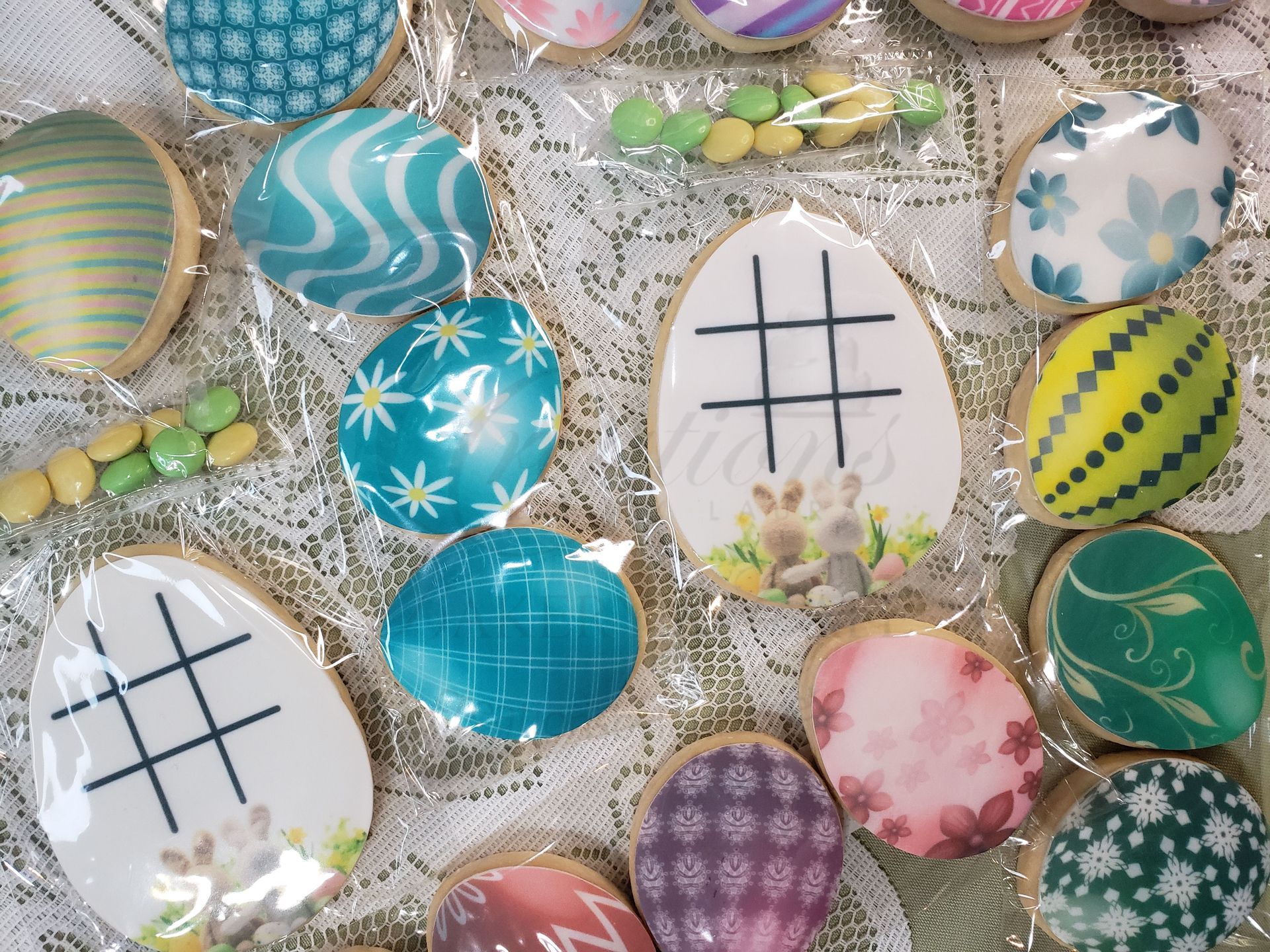 Decorated Easter eggs in pastel colors with patterns, scattered in a basket or tray.
