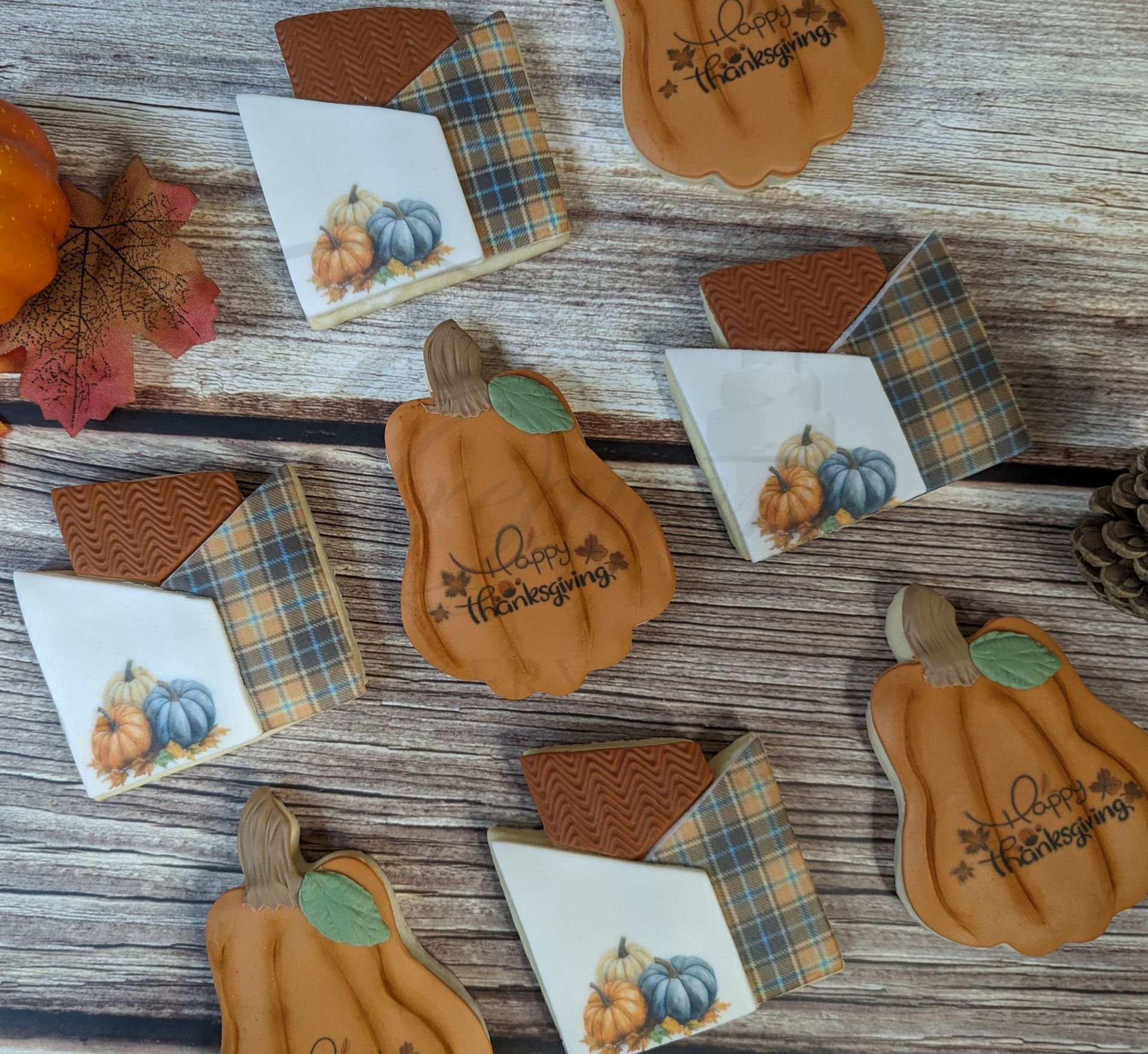 Fall pumpkin-themed place cards and favor boxes on a rustic wood background.