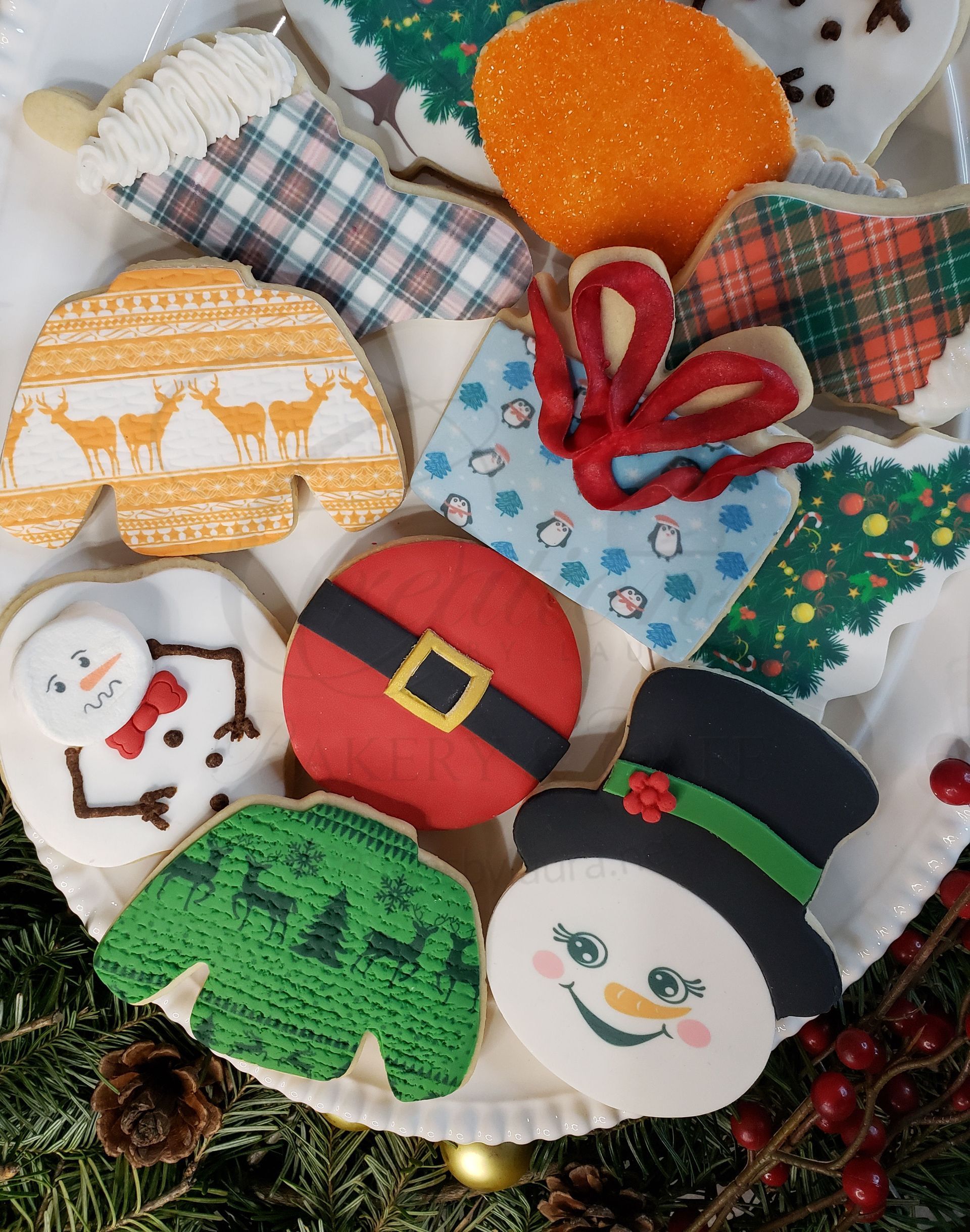 Assorted decorated Christmas cookies with snowmen, presents, and holiday patterns on a tray.