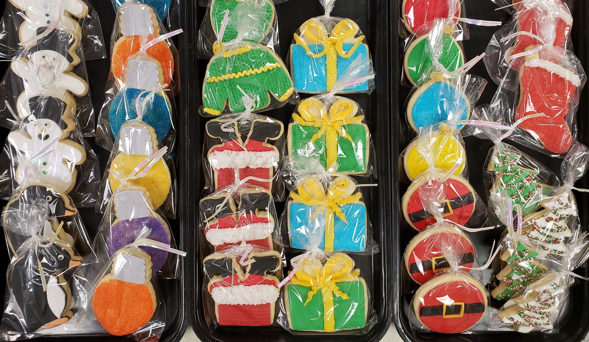 Wrapped colorful lollipops in rows, in red, green, yellow, orange, and purple wrappers.