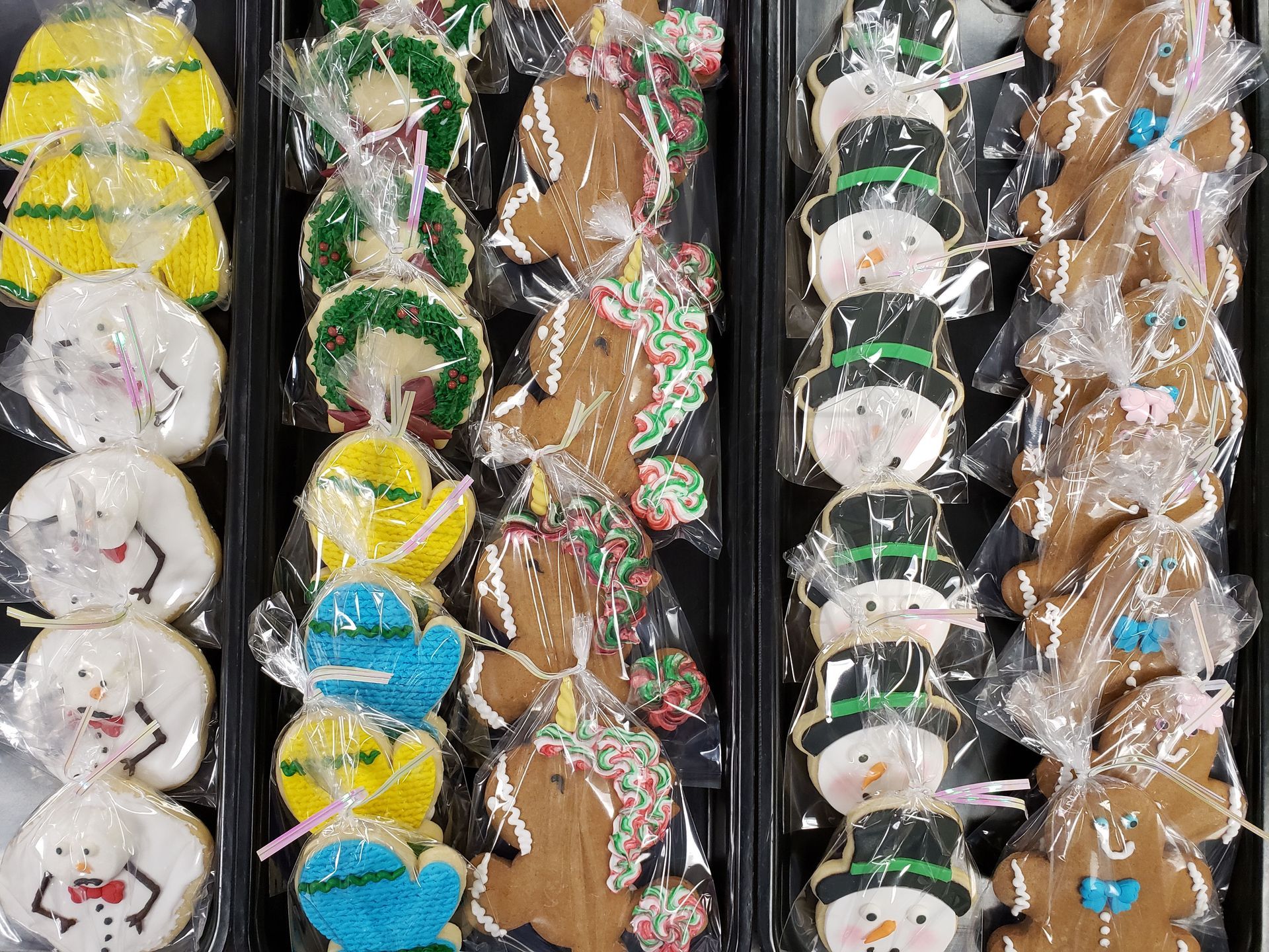 Assorted packaged confections in vertical rows, including white, green, yellow, and brown treats.