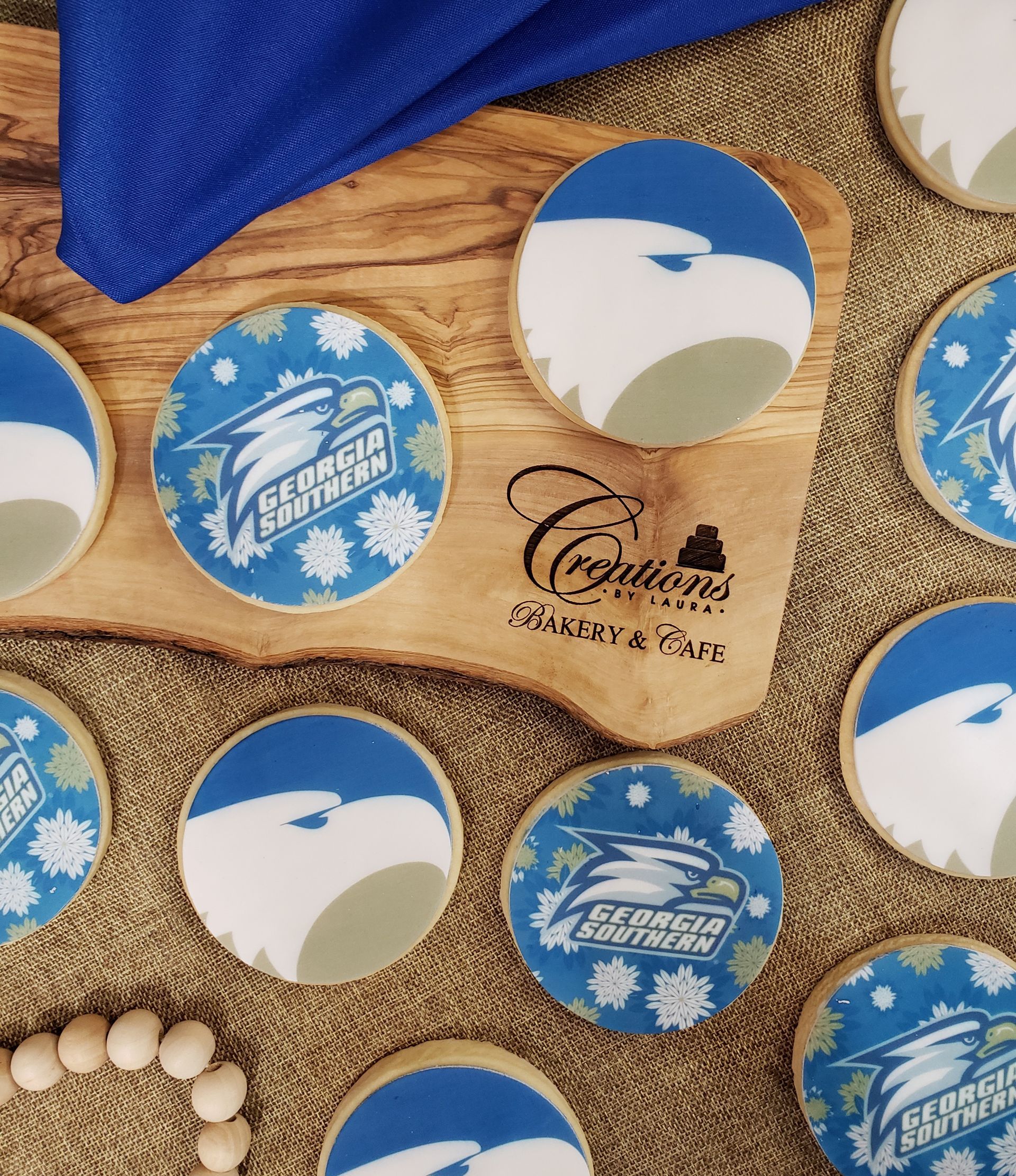 Blue-and-white custom buttons on burlap with a navy cloth and seashells.