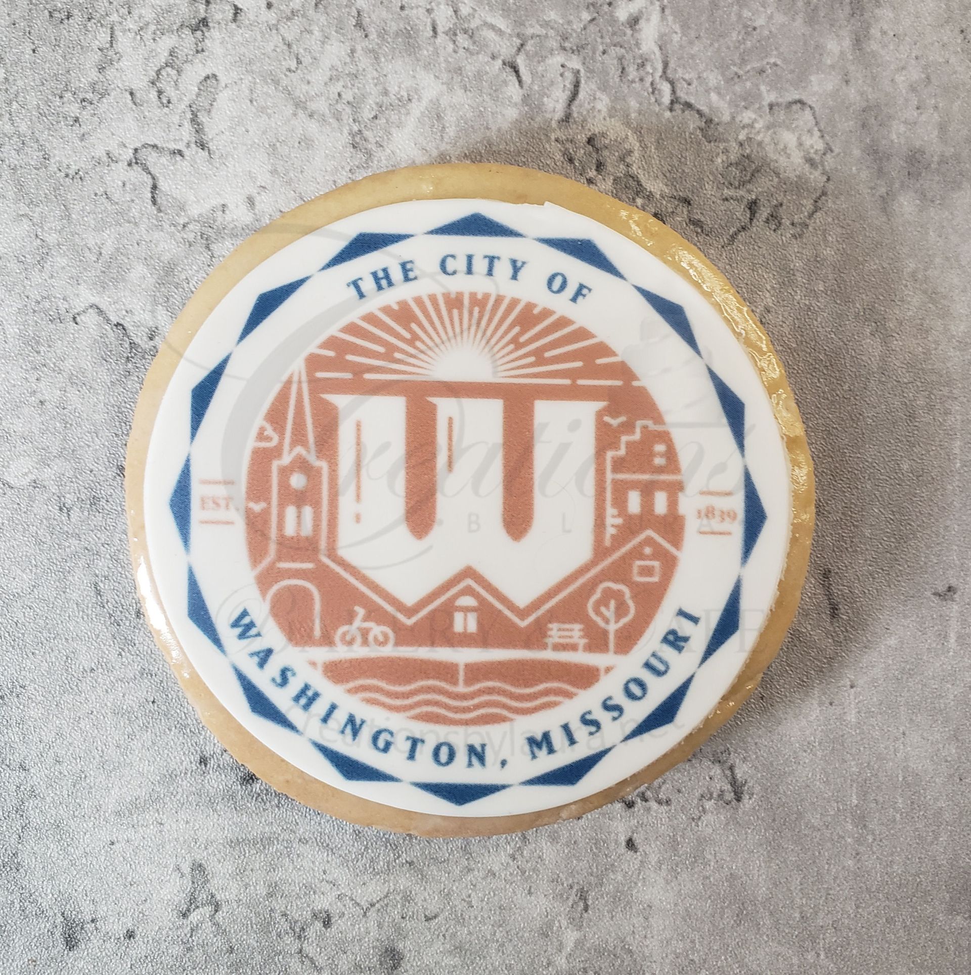 Round city seal reading The City of Washington, Missouri, on a gray concrete surface.