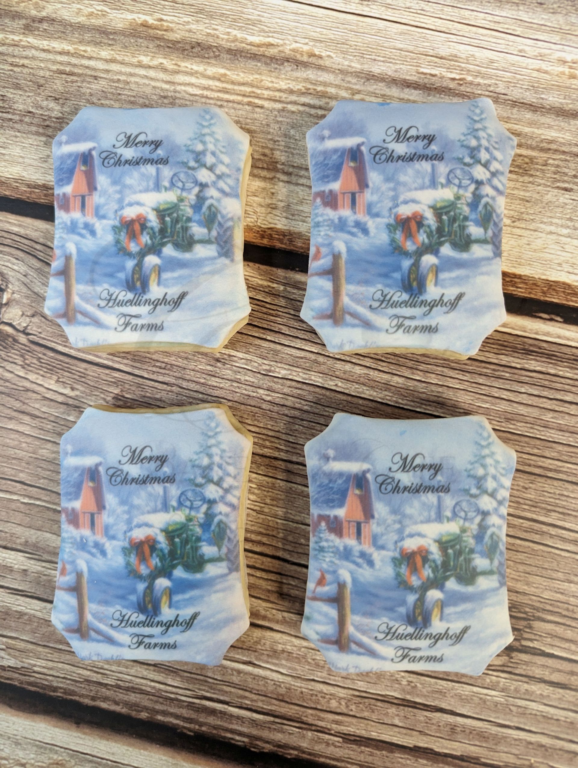 Four small vintage-style Christmas cards with snowy winter scenes on a wooden table.