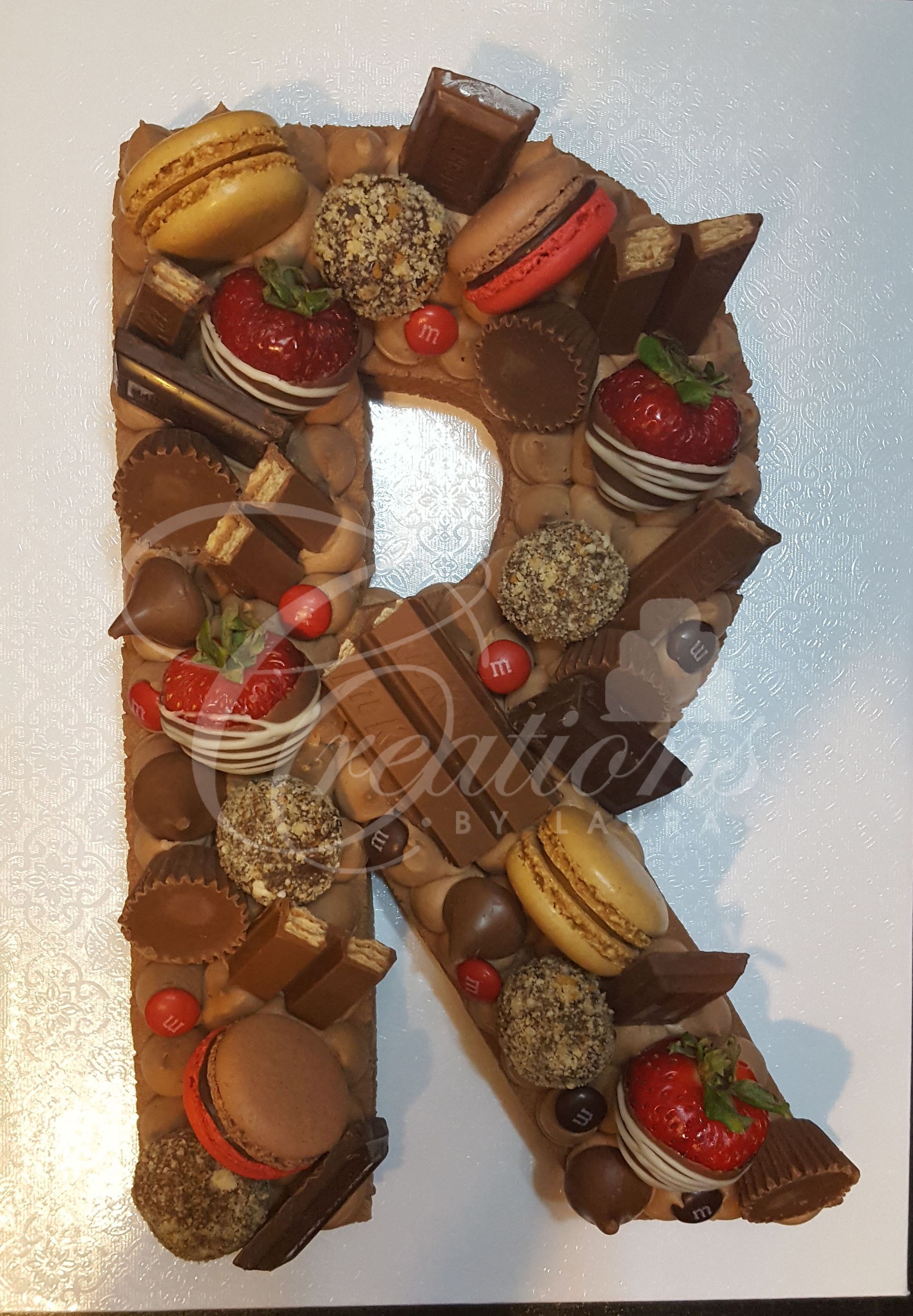 A letter r made out of chocolates and strawberries