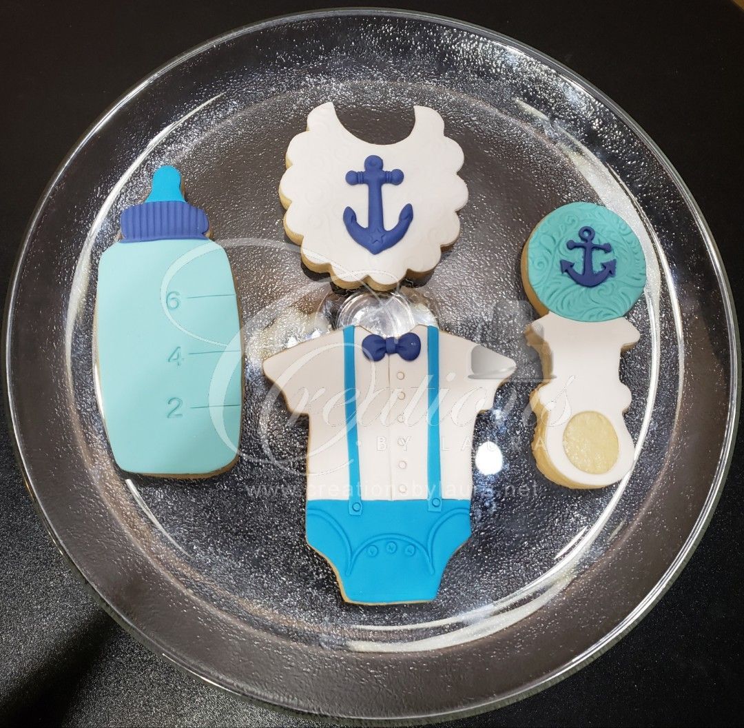 A baby shower cookie set with a bottle bib and pacifier