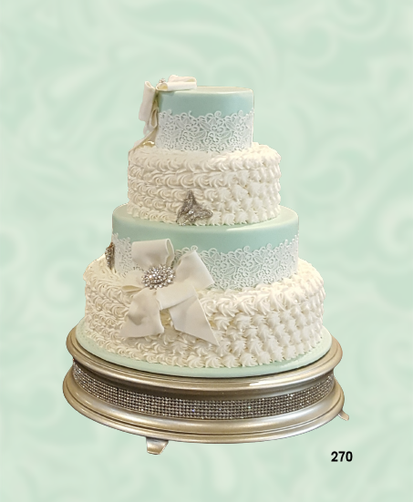 Three-tier white and pale aqua wedding cake with lace details and silver stand