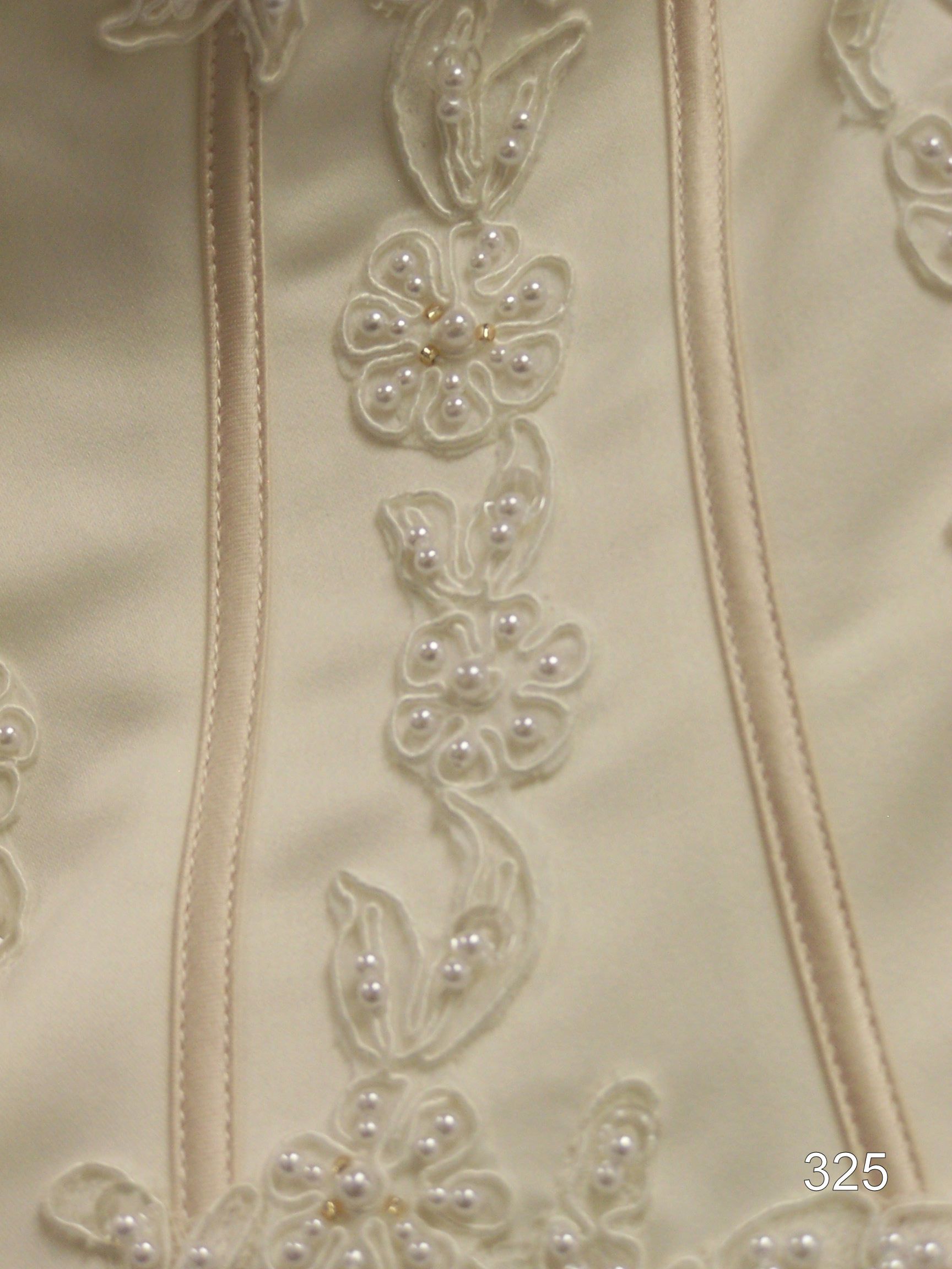 Cream satin fabric with vertical stitched seams and floral bead embroidery in the center