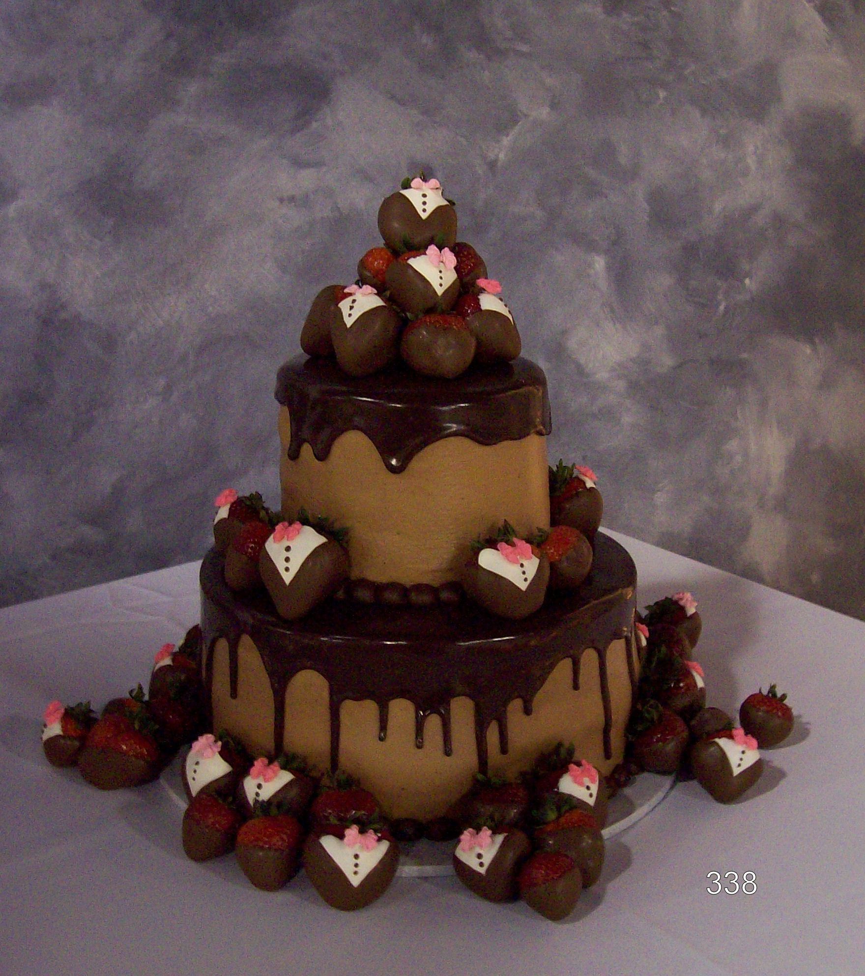 Three-tier chocolate strawberry cake with drips, topped and surrounded by chocolate-dipped strawberries.