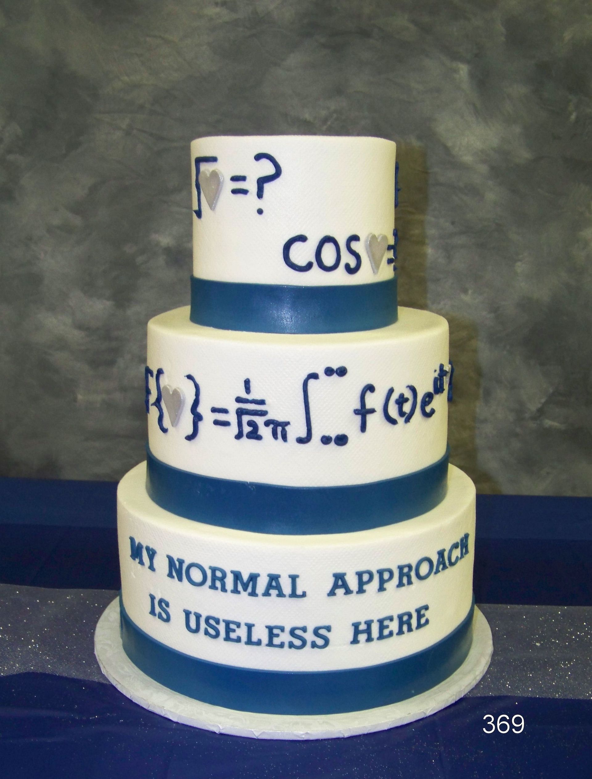 Three-tier cake with math formulas and the words “MY NORMAL APPROACH IS USELESS HERE” on blue and white icing