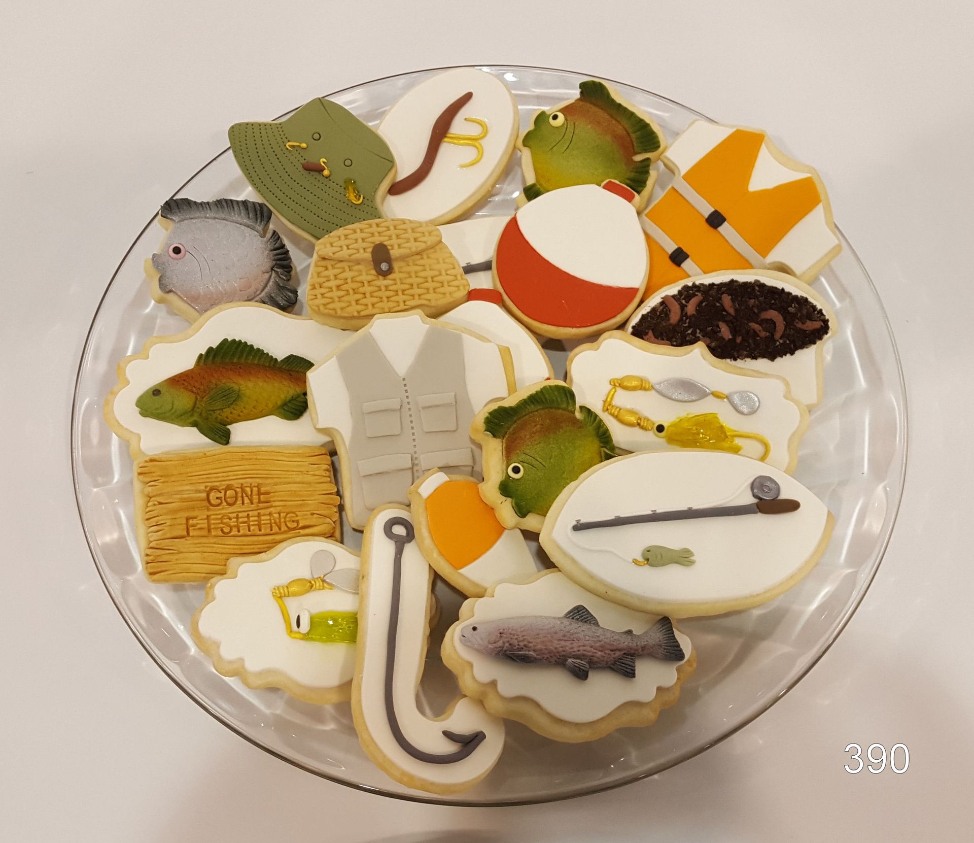 Assorted decorated cookies arranged on a clear round plate
