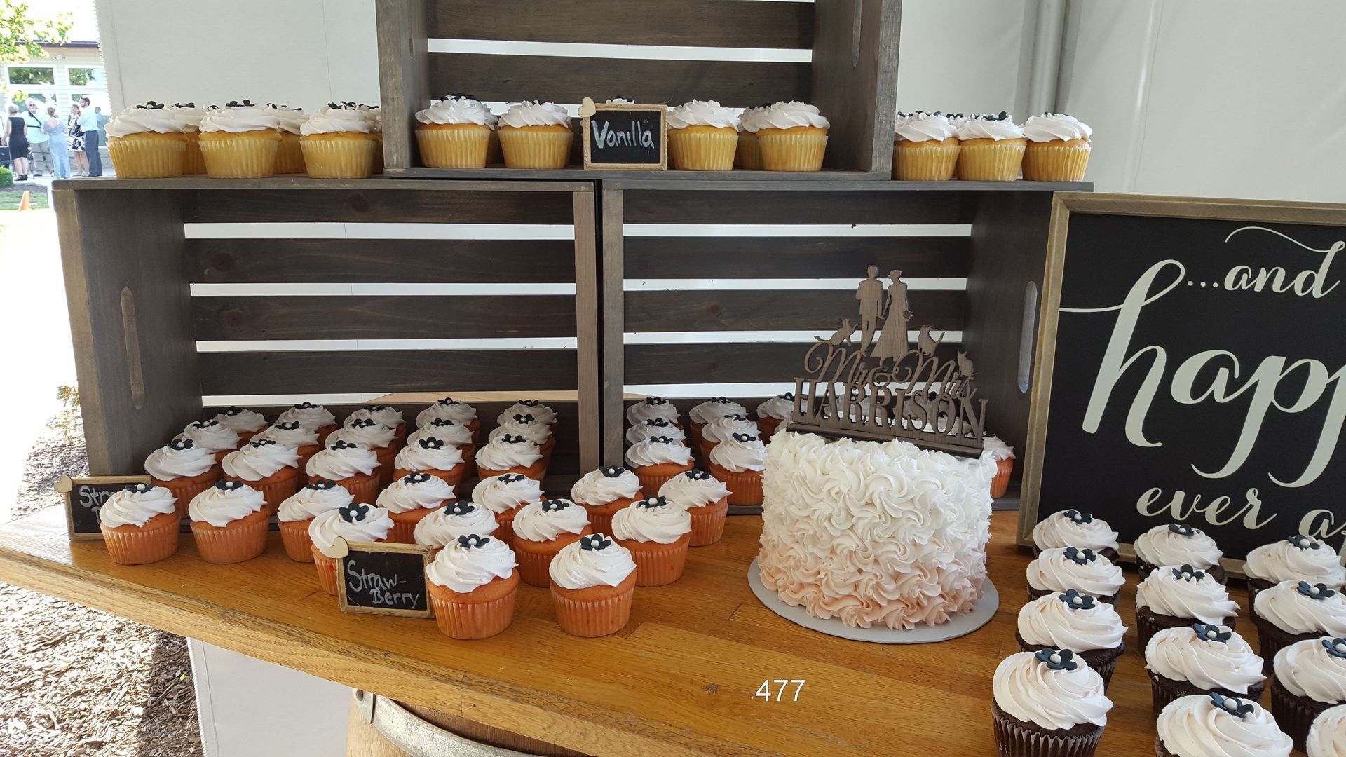 Dessert table with cupcakes, cake, and a