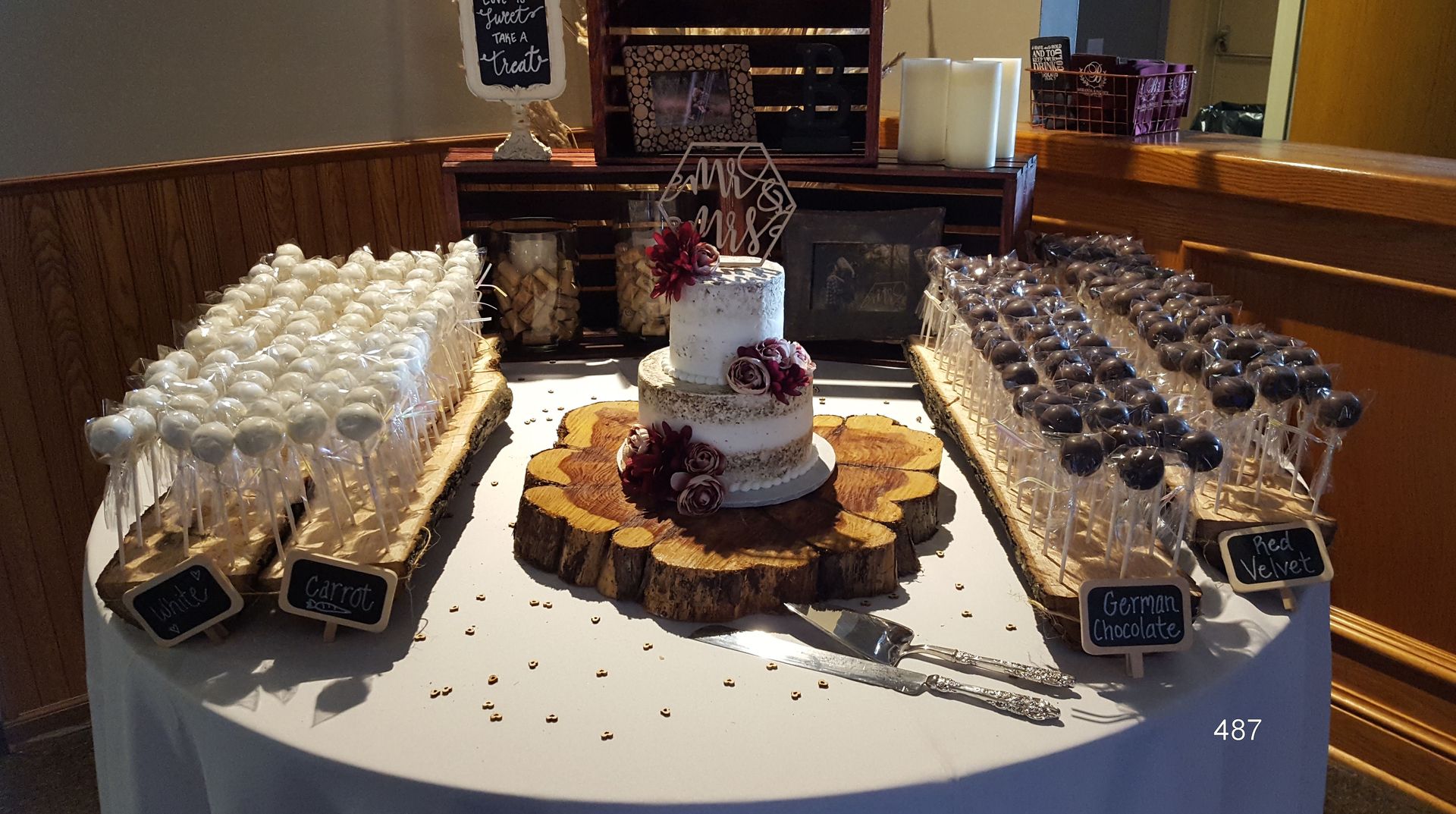 Dessert buffet with cupcakes and pastries arranged on a white table in a bakery or event setting
