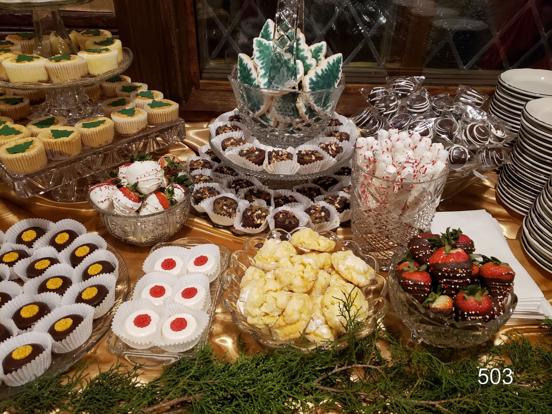 Assorted colorful desserts and pastries arranged on trays at a buffet table.