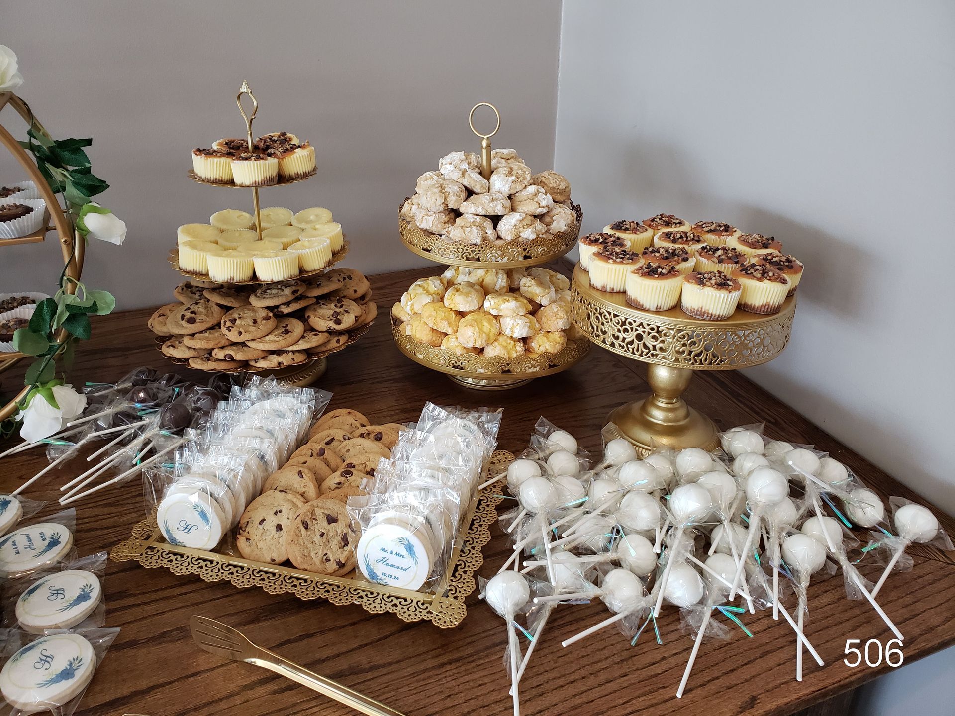 Dessert display with tiered trays of cupcakes and cake pops on a decorated table