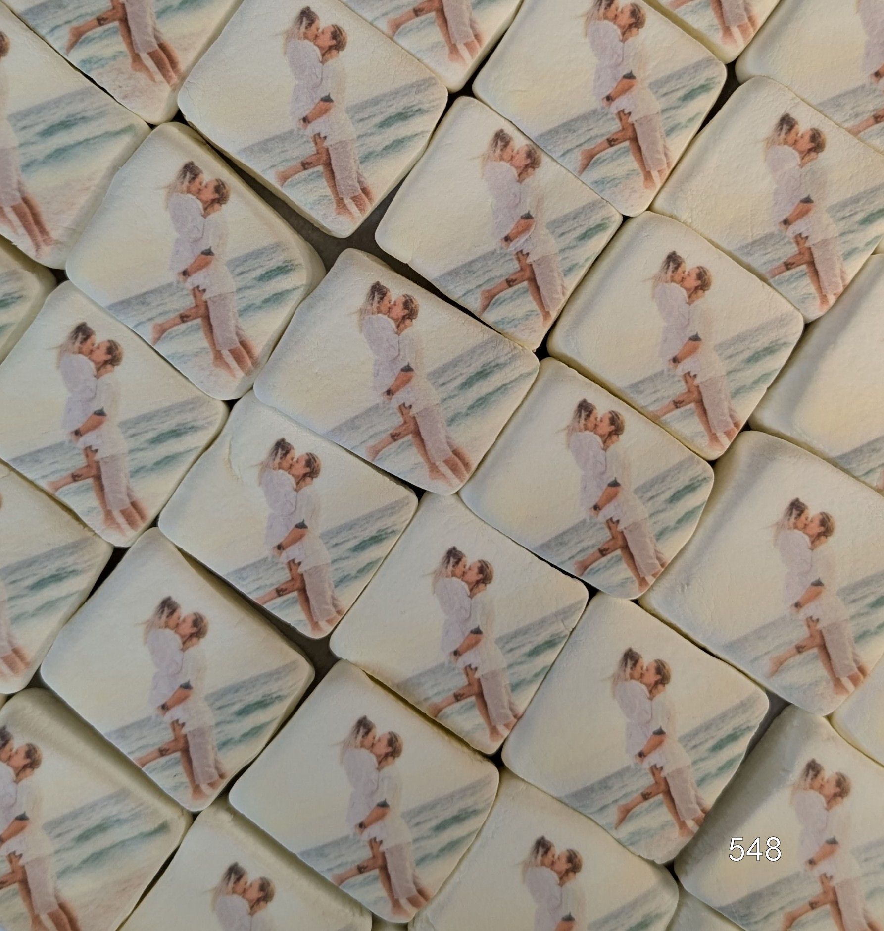 A tiled pattern of rotated square photos showing a couple dancing in soft pastel tones