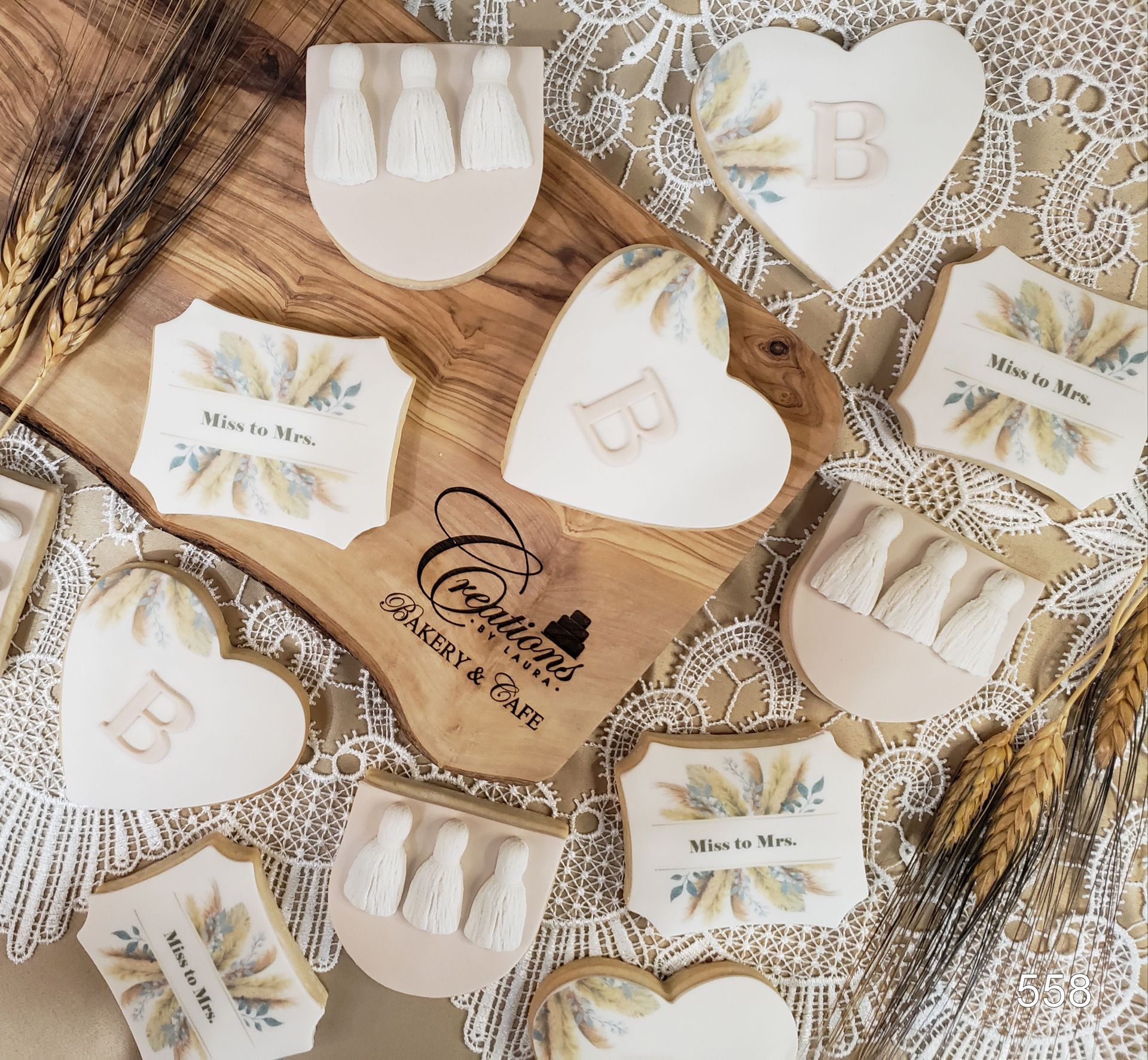Heart-shaped wedding favors and invitation cards arranged on lace and wood decor.