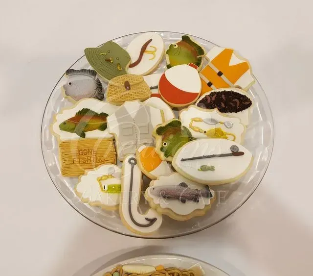 Round clear container filled with assorted colorful decorated cookies and sweets