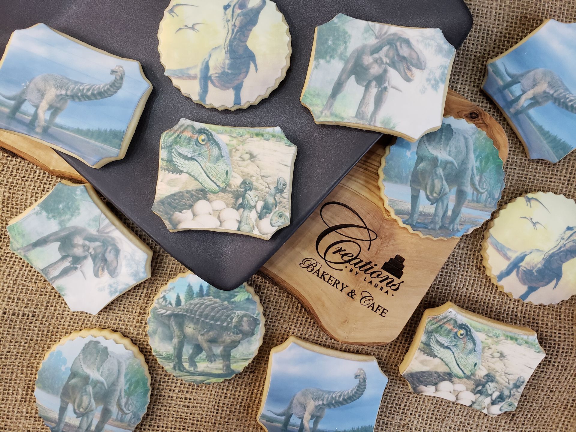 Assorted blue-toned coasters and a tan tag with a logo on a burlap surface