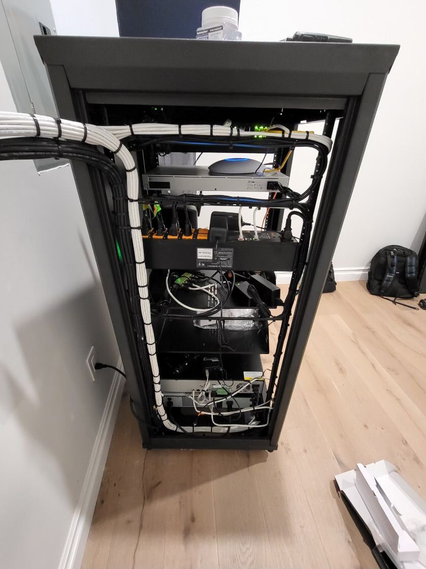 A server rack with a lot of wires coming out of it.