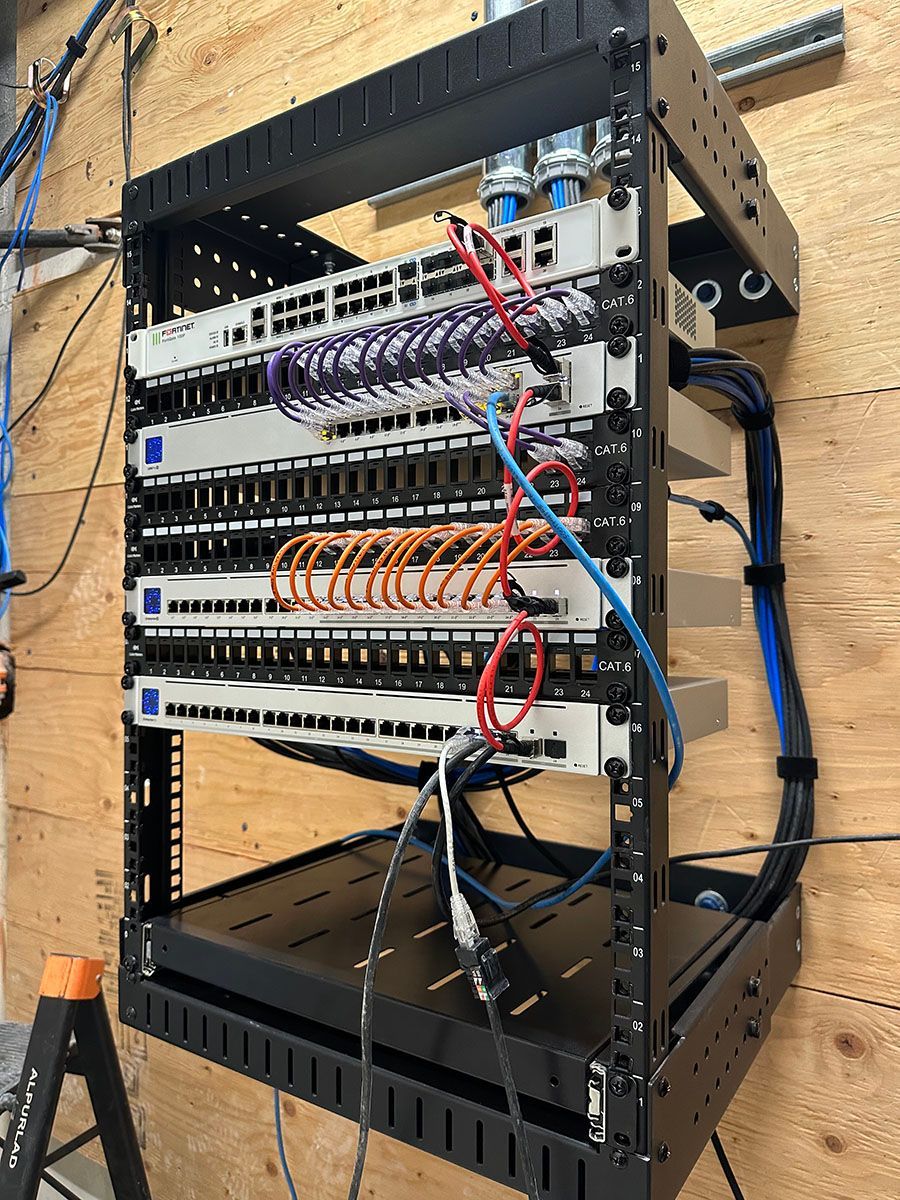 A server rack with a lot of wires coming out of it.