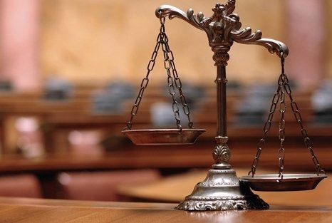 Scales of justice in a courtroom setting, symbolizing fairness and legal balance.