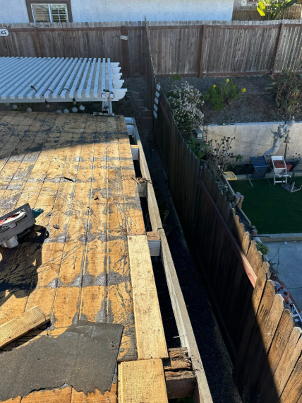 Flat roof and narrow gap between fences, with a backyard pool and small patio visible below.