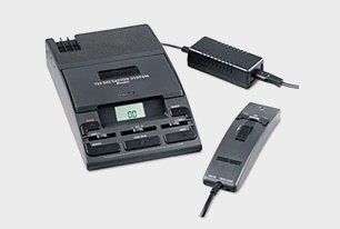 Black tape recording system with power adapter and remote control.