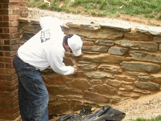Man repairing stone wall