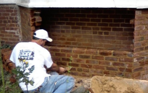 Man repairing the old brick wall