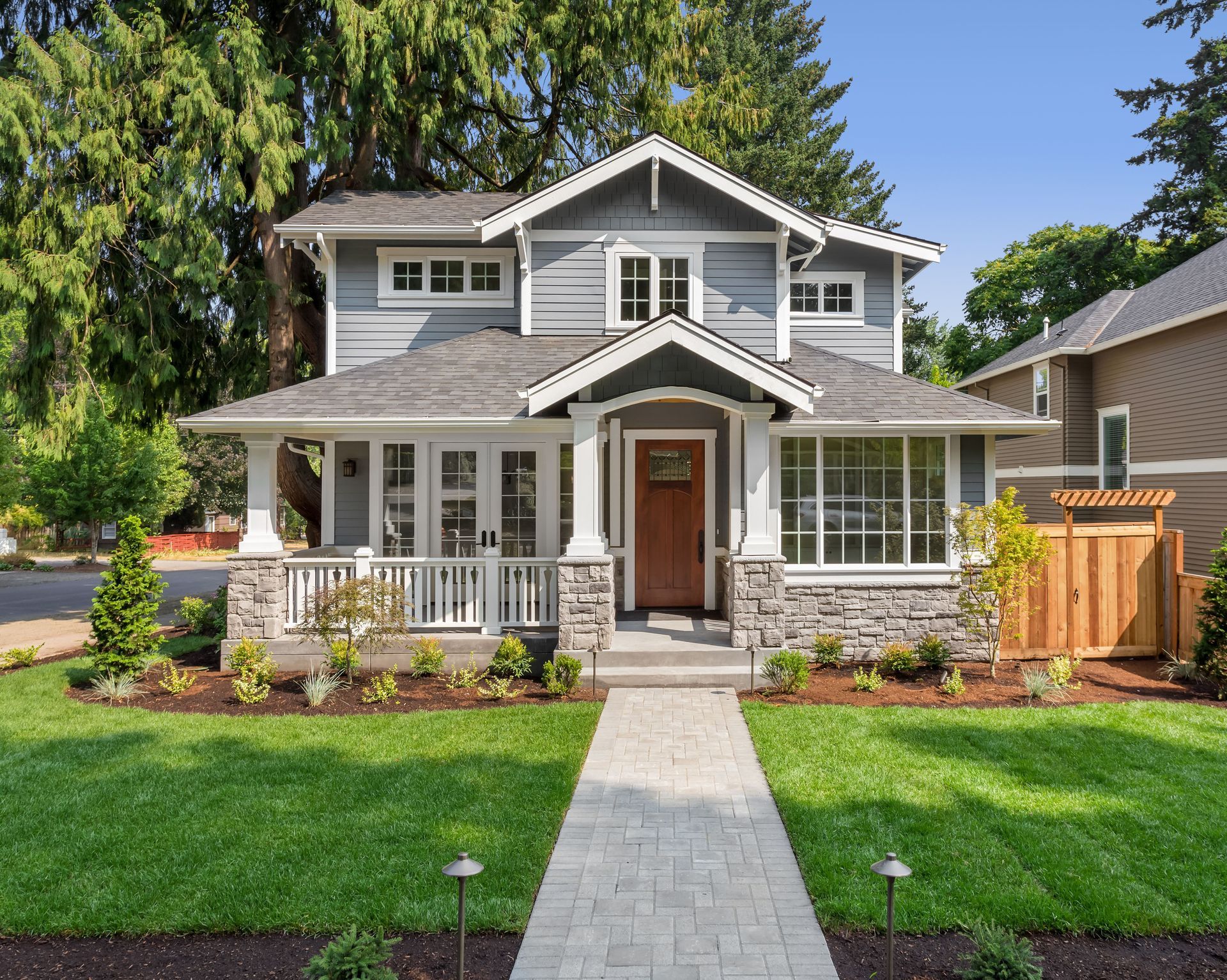 A house with a brick walkway leading to the front door