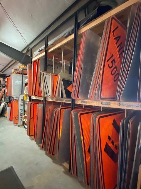A stack of orange signs with one that says lane 1500