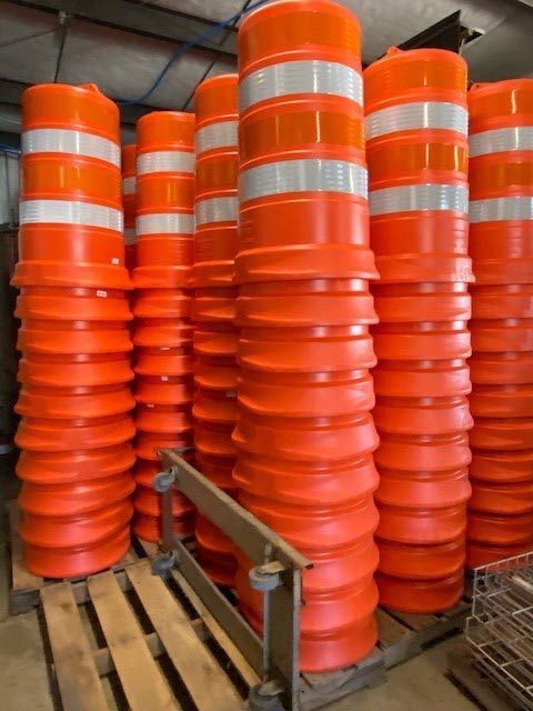 A bunch of orange traffic cones stacked on top of each other