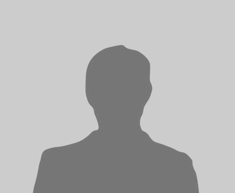 HVAC technician in yellow hard hat working on an outdoor air conditioning unit, using a screwdriver.