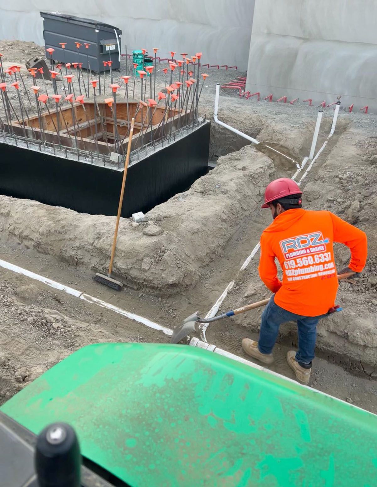 A man covering the pipes on a construction site