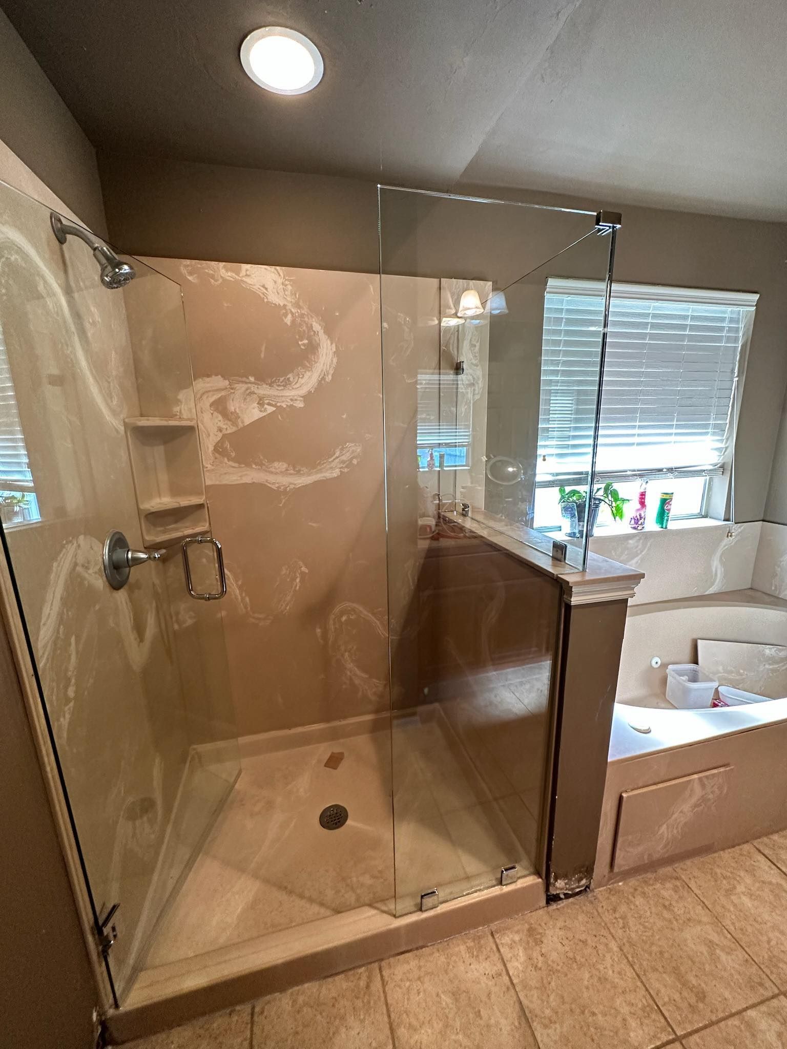 A bathroom with a walk in shower and a bathtub.