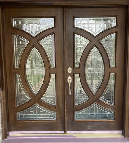 a wooden door with stained glass .