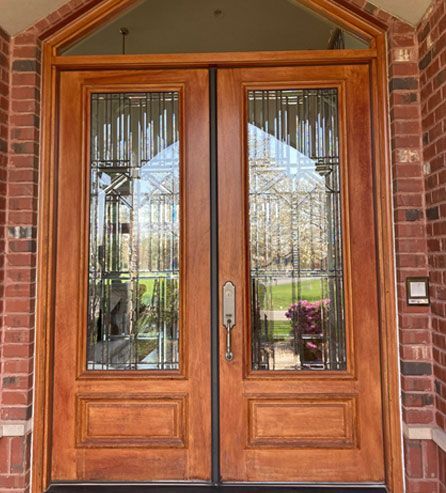 a wooden door with stained glass 