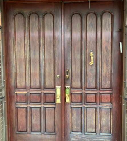 a wooden door with gold handle