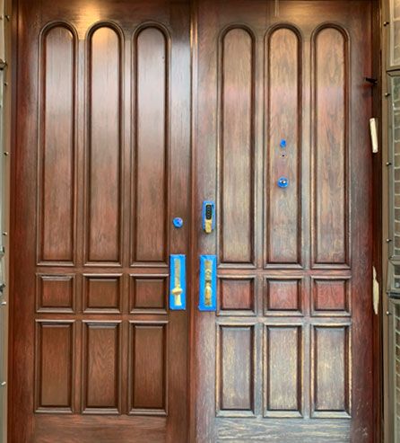 a pair of wooden doors with blue tape on them