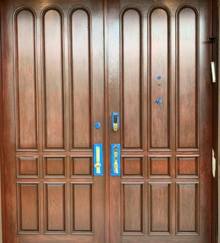 a wooden door with blue handles