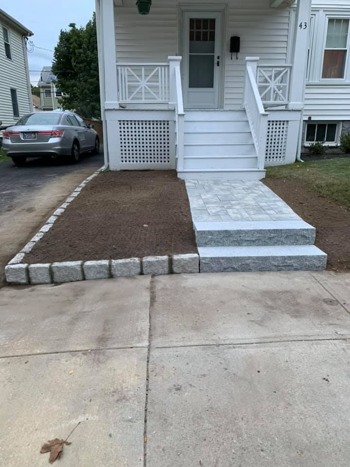 A white house with a car parked in front of it