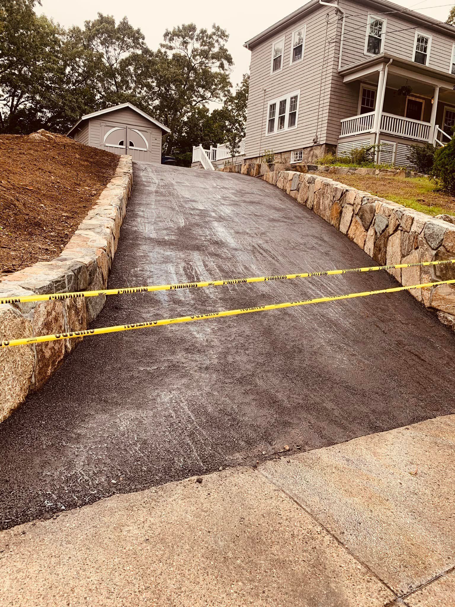A driveway is being built in front of a house.