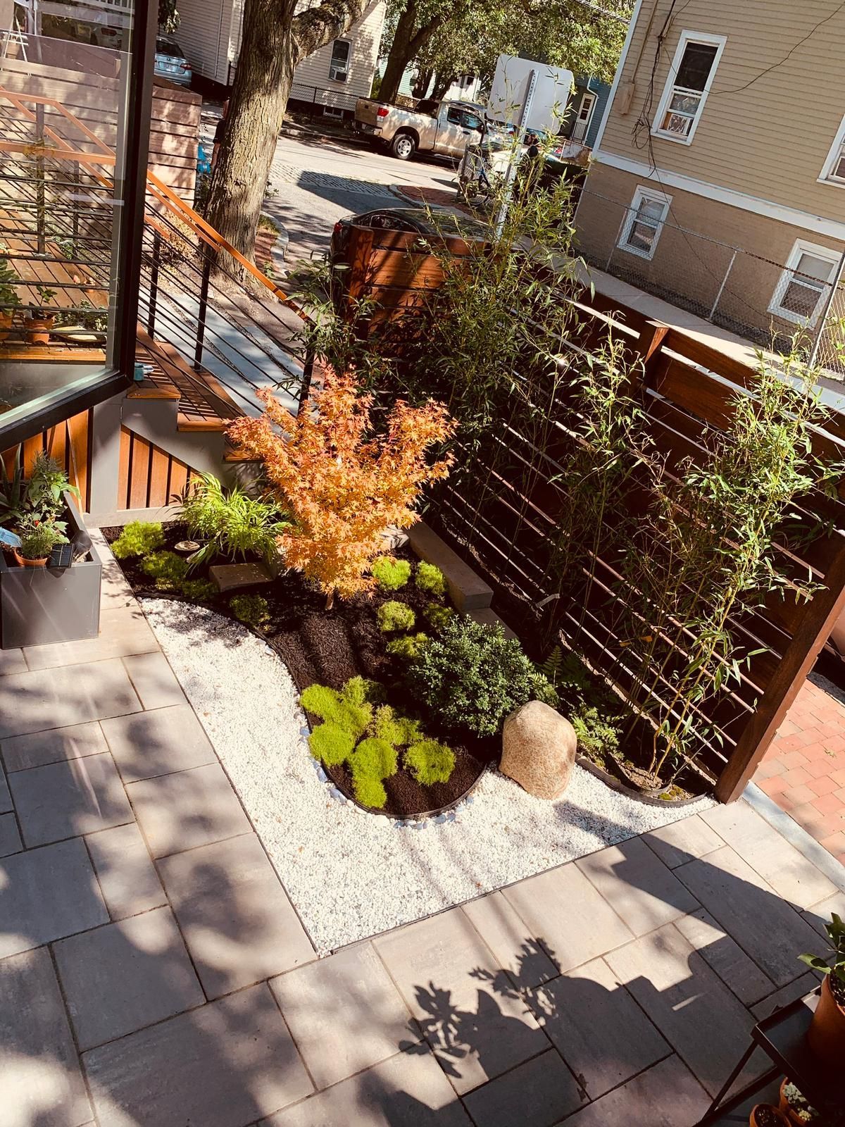 An aerial view of a garden with a fence and stairs leading up to it.