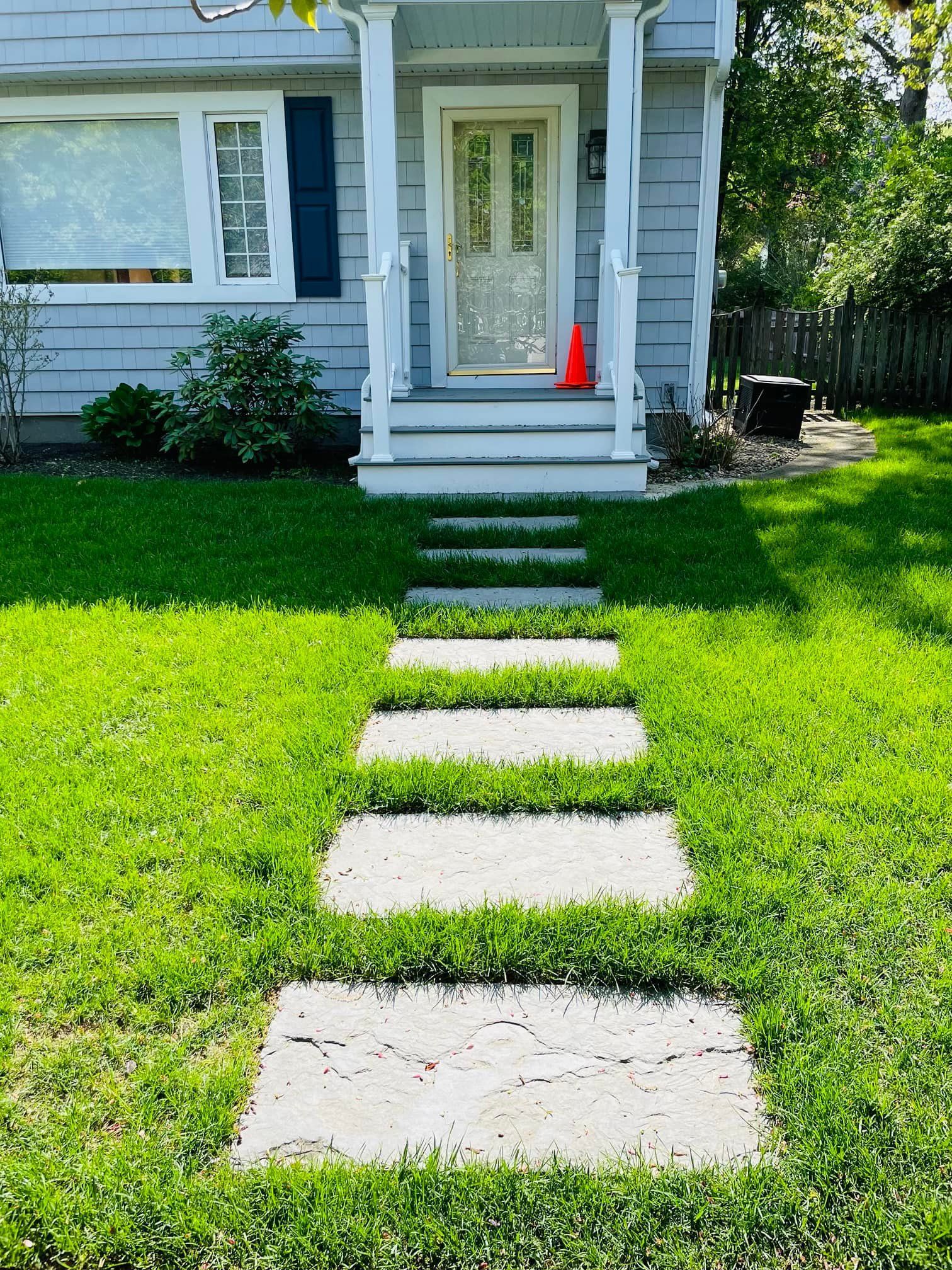 A stone walkway leading to the front door of a house.