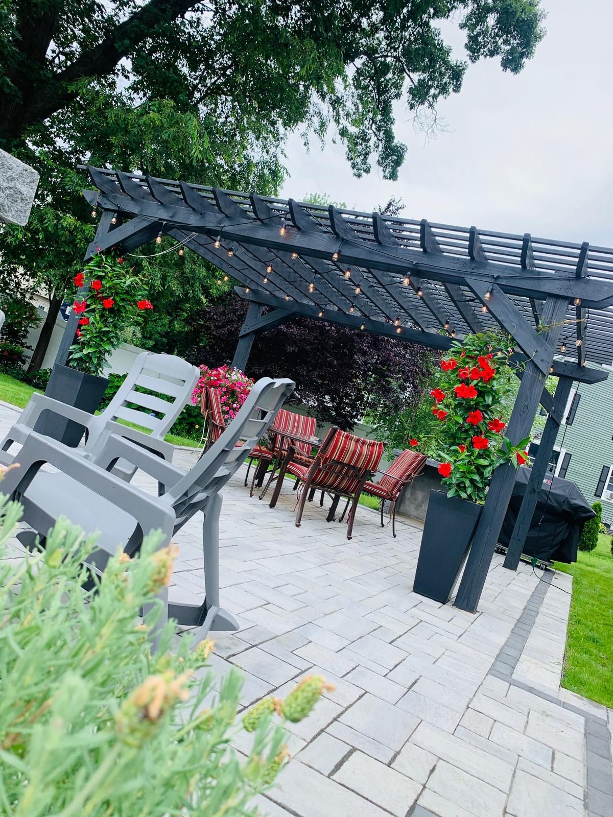 There is a pergola with a table and chairs underneath it.