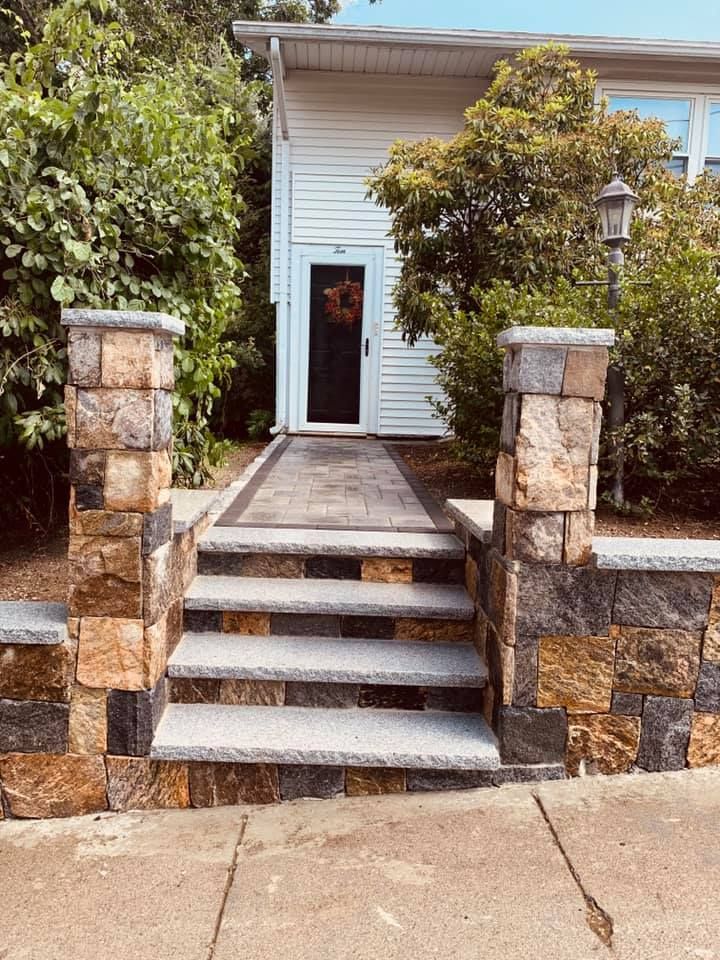 A stone walkway leading to the front door of a house.