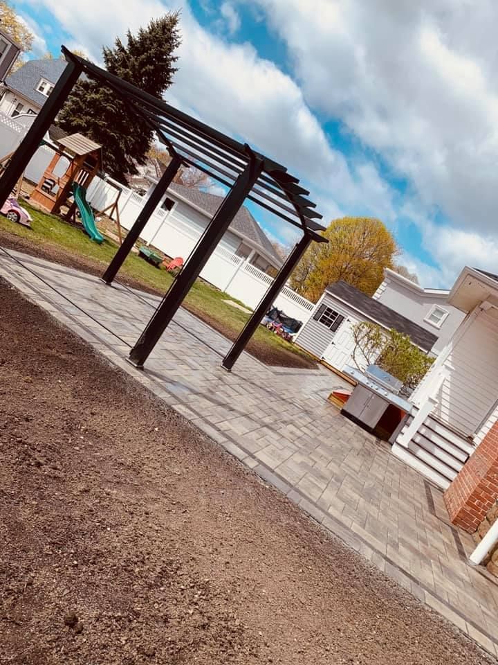 There is a pergola in the backyard of a house.