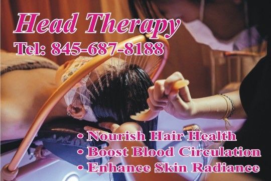 A woman is brushing another woman 's hair at head therapy